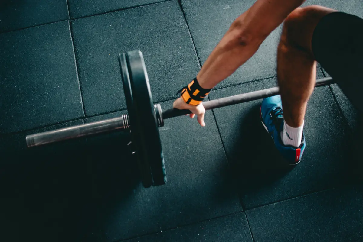 Athlete gripping a loaded barbell